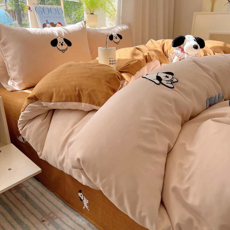 A beige and brown cartoon embroidered bedding set featuring dog faces for kids and adults.