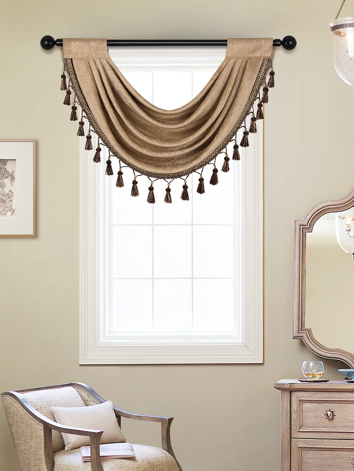 A beige window curtain valance with tassels is draped over a white-framed window.