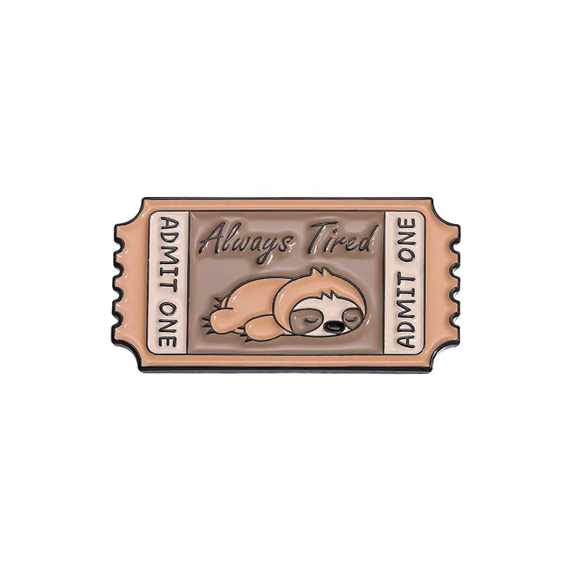 A vintage enamel lapel pin featuring a design with the text Always Tired and Admit One.