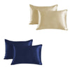 A set of two satin silk pillowcases, one in champagne gold and one in navy blue.