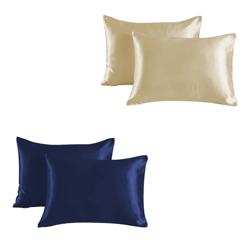 A set of two satin silk pillowcases, one in champagne gold and one in navy blue.