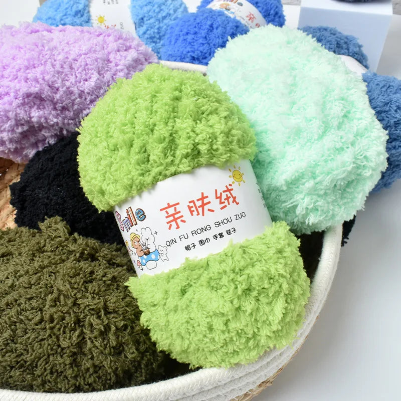 A collection of fluffy yarn balls in various shades including purple, blue, green, and black.