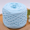 A ball of light blue craft yarn for knitting and DIY displayed on a wooden surface.