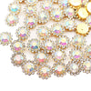 A close-up of gold and clear crystal rhinestone sew-on buttons arranged in a floral pattern.