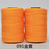 Two spools of bright orange hand knitting and crochet cord for crafting