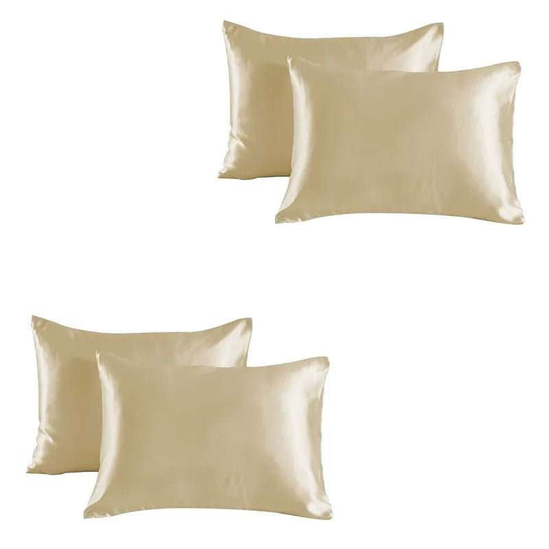 A set of two smooth, champagne-colored satin silk pillowcases.
