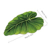 A green, leaf-shaped quick-dry bathroom mat with a rubber backing shown from above.