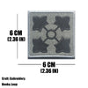 A square gray embroidered tactical patch featuring four dark star shapes arranged in a cross pattern.