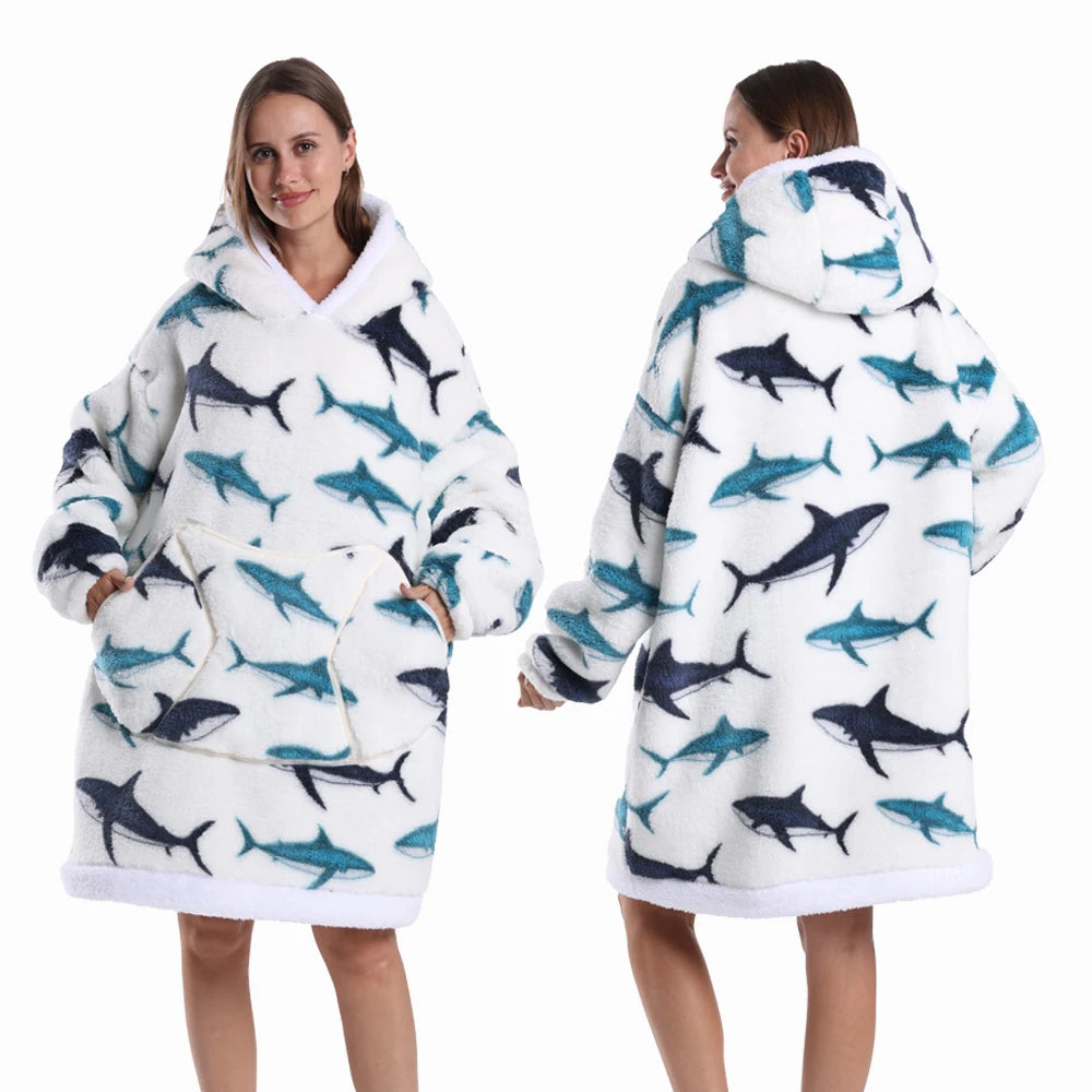 A woman models an oversized patchwork fleece hoodie with a white and blue fish print.