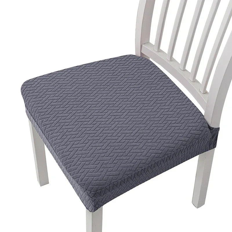 Gray removable polyester bar and dining seat covers on a white wooden chair.