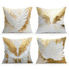 Decorative throw pillow covers featuring white and gold wing designs.