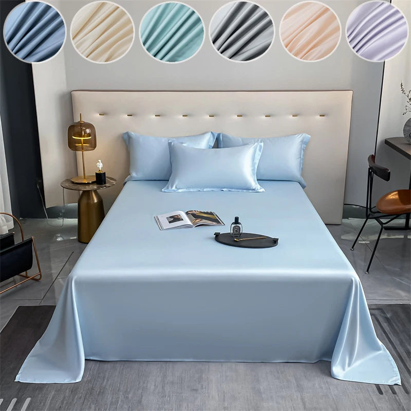 A bed dressed with light blue luxury bamboo flat sheets and pillows, featuring a modern white headboard.