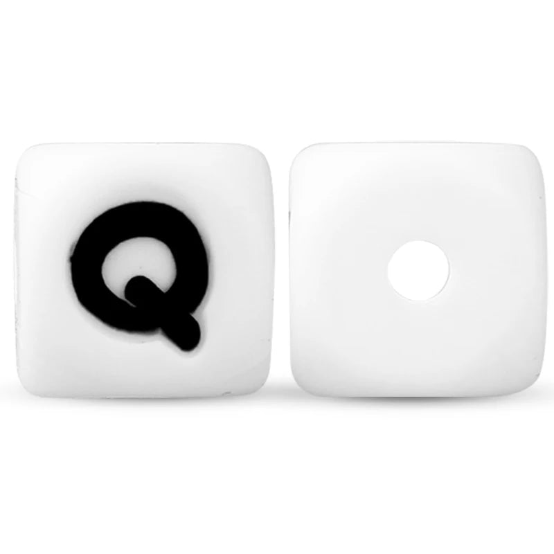 A pair of white silicone alphabet beads, one showing the letter Q and the other blank.