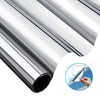 Silver aluminum window film rolled up, showing a cross-section view of the material.