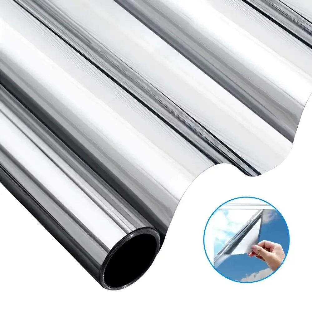 Silver aluminum window film rolled up, showing a cross-section view of the material.