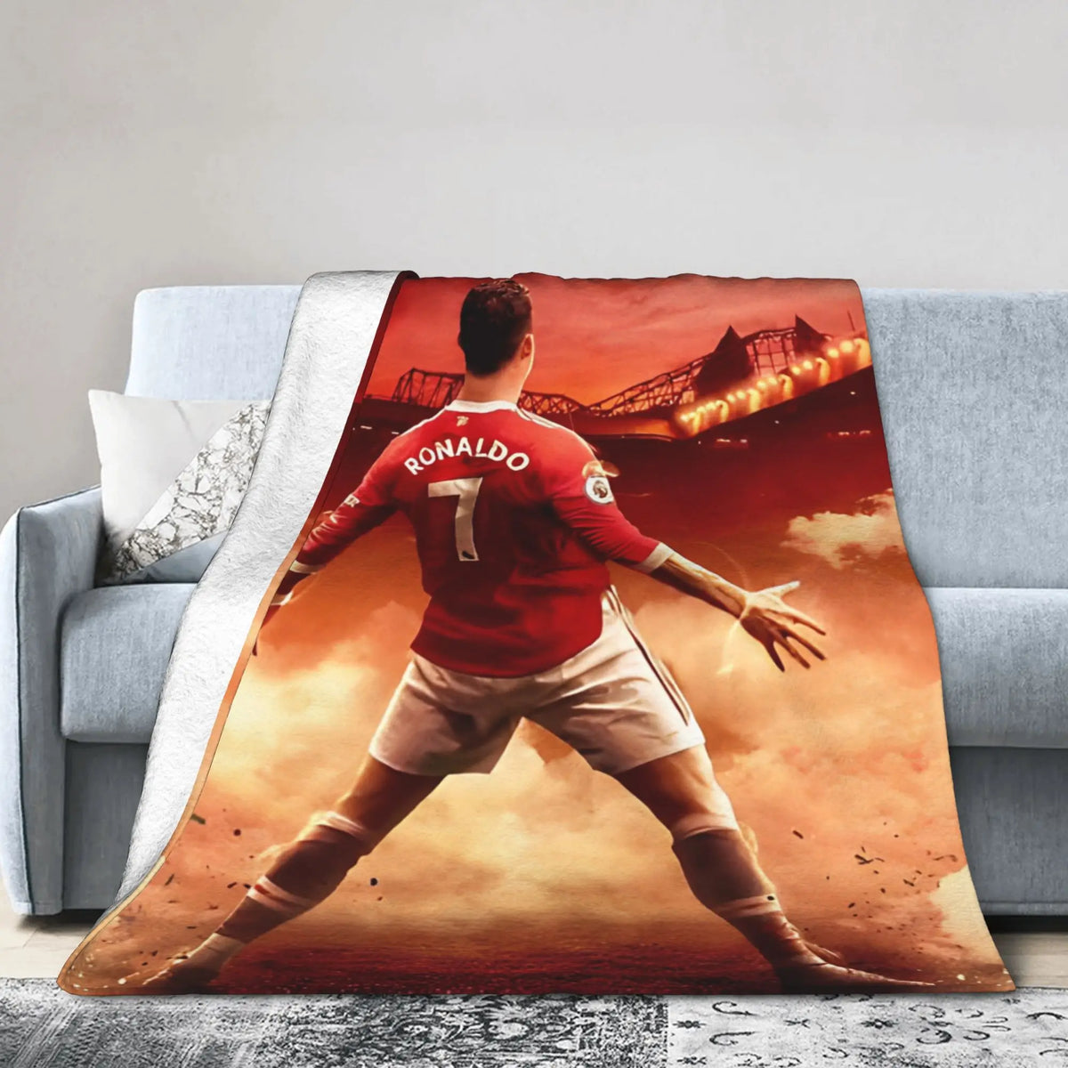 A football player wearing a red jersey with the number 7 is shown in a dynamic pose on a blanket.