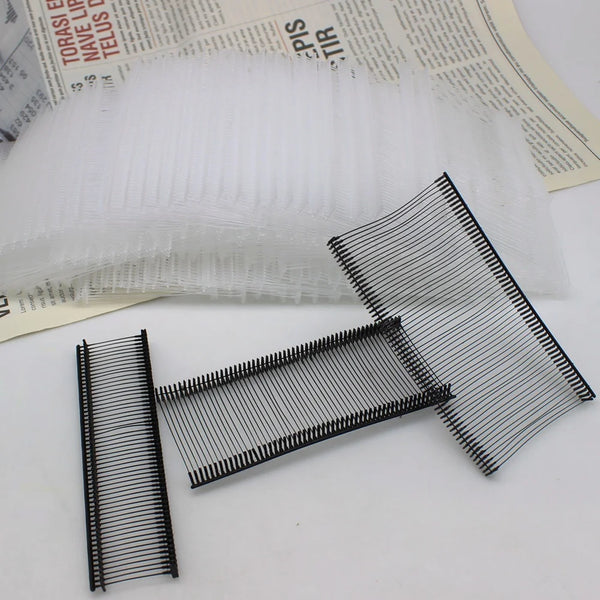 A close-up view of precision plastic tagging barbs used for labels, showing various sizes and angles.