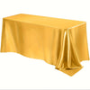 A smooth, golden satin tablecloth draped elegantly on a table.