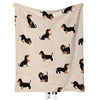 A light beige flannel blanket featuring a repeating pattern of black dachshund silhouettes.