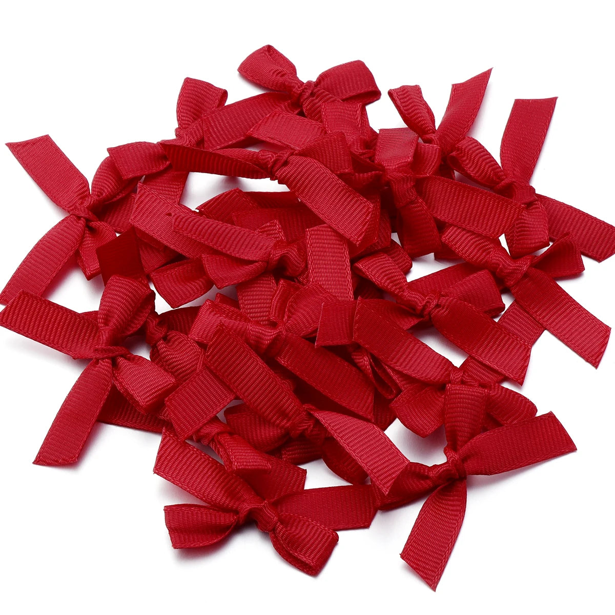 A pile of red satin ribbon bows for craft and decoration.