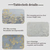 Details of a light blue tablecloth featuring gold floral stamping and lace trim.