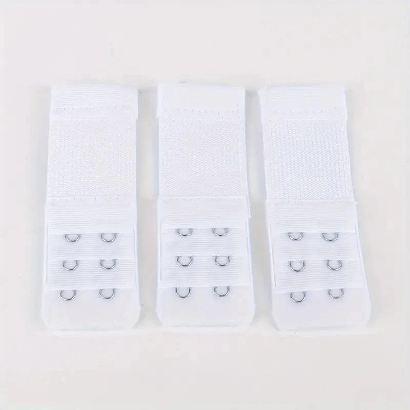 Three white adjustable bra extender straps laid out side by side.