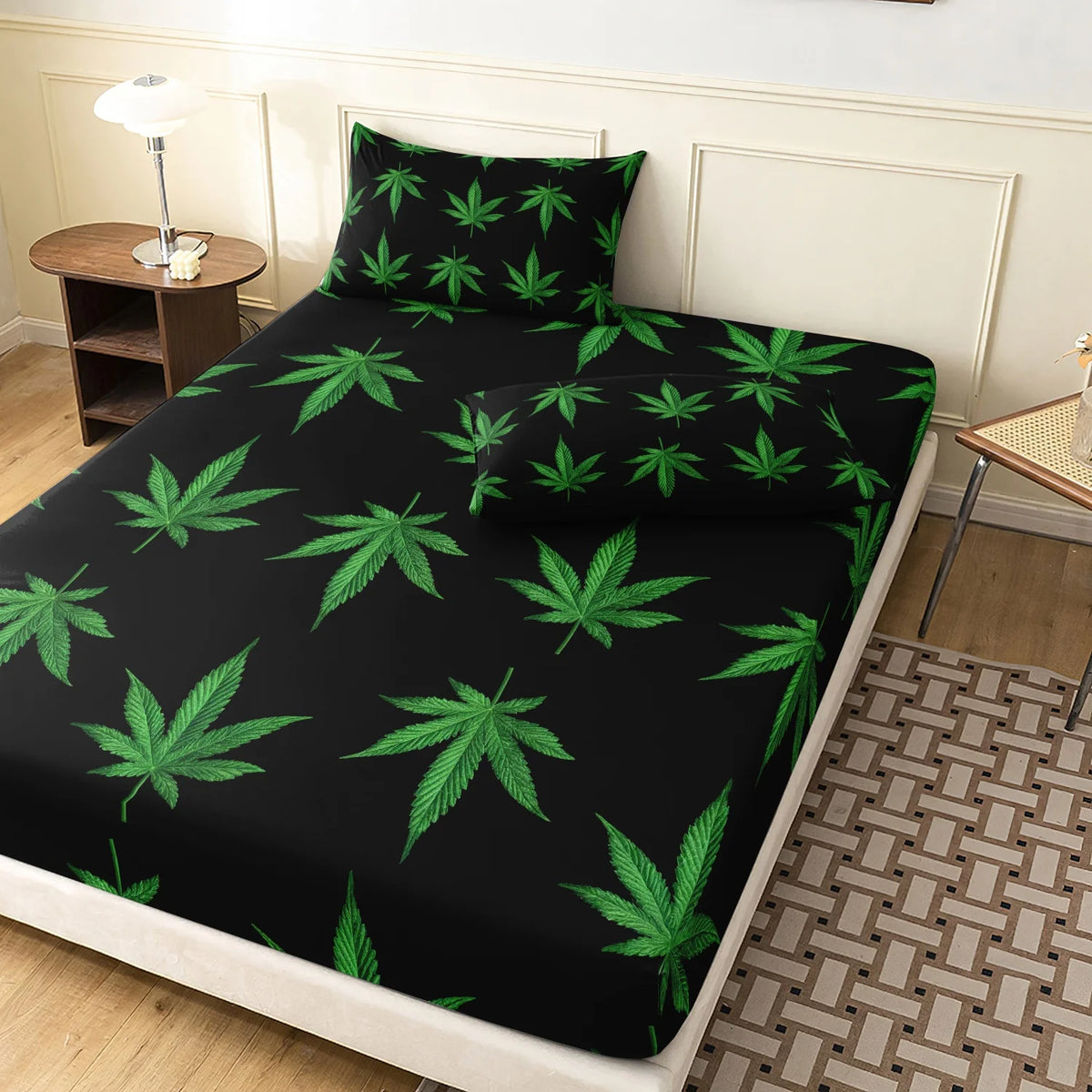 Black fitted sheet with a vibrant green cannabis leaf print on a bed.