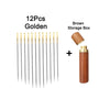 A set of 12 gold stainless steel sewing needles and a brown storage box.