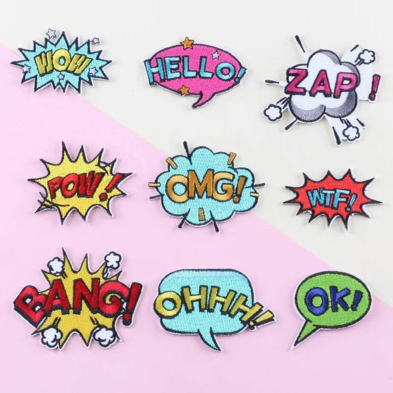 A collection of colorful embroidery patches featuring various exclamation and speech bubble words like WOW, HELLO, ZAP, POW, 