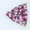 A flatback tray filled with pink and silver crystal rhinestones for crafts and decor