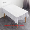 White satin table runner displayed on a wooden table, showing the fabric texture and drape.