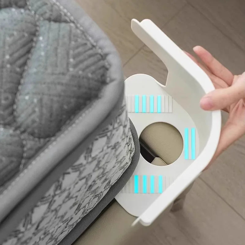 A hand is holding a white clip designed to fix an invisible bed sheet, showing the mechanism for securing fabric.