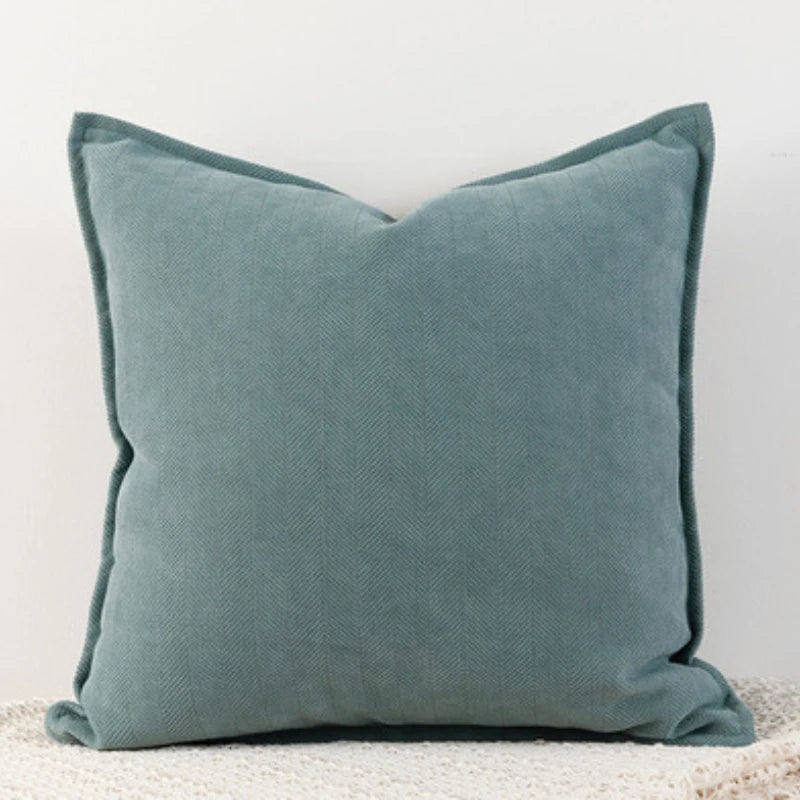 A solid teal chenille throw pillow cover with a textured fabric.