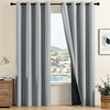 A set of two modern gray blackout grommet curtains hanging in a window frame.
