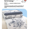 A white duvet cover featuring a floral pattern with gray accents, rolled neatly on a light-colored bed.