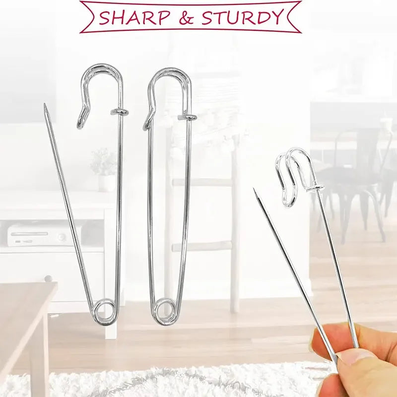 Three heavy duty stainless steel safety pins are shown against a white background.