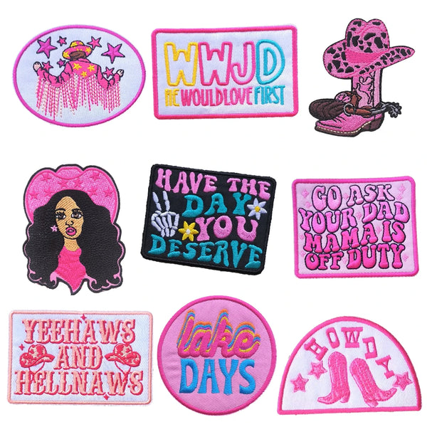 A collection of iron-on embroidered letter patches featuring various phrases and designs like WWJD and Have The Day You Deser