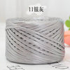 A spool of silver metallic cake yarn for crafting, tightly wound and cylindrical.