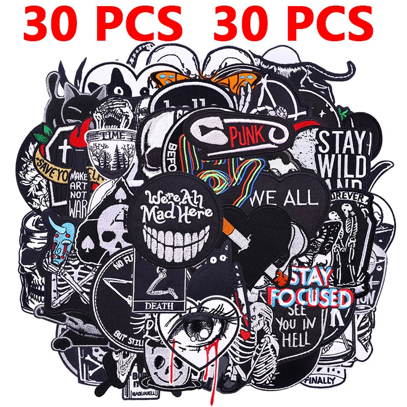 A pile of random mixed black and white punk embroidered patches for DIY clothing
