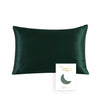 A dark emerald green silk pillowcase with a subtle crescent moon design.