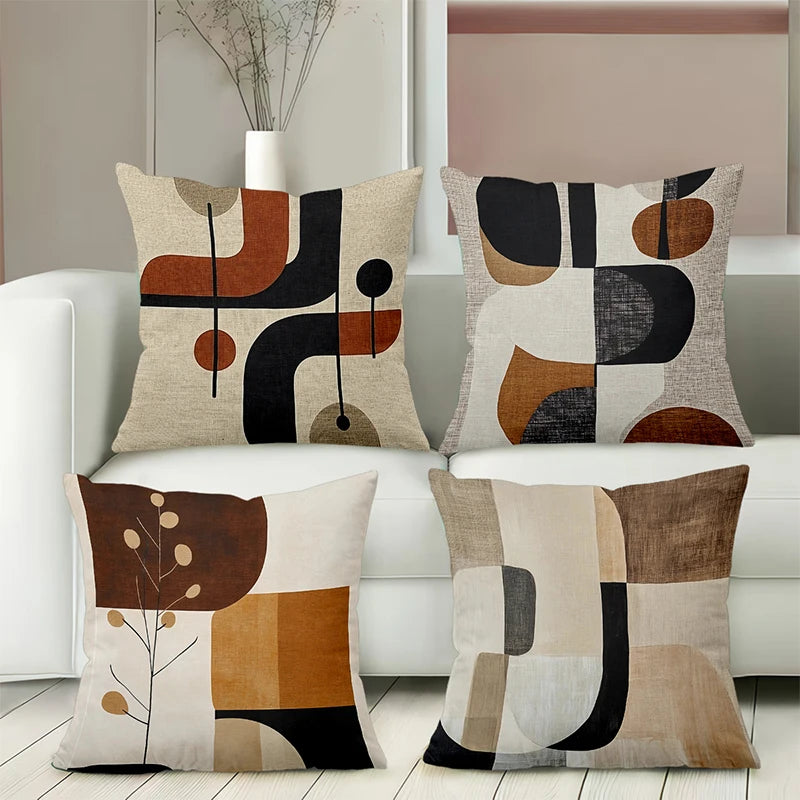 A set of four decorative pillows featuring an abstract geometric pattern in earth tones and black on a light background.