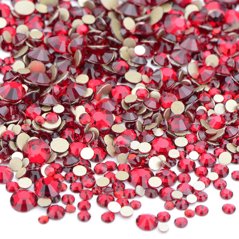 A pile of red and gold glass rhinestones for DIY crafts