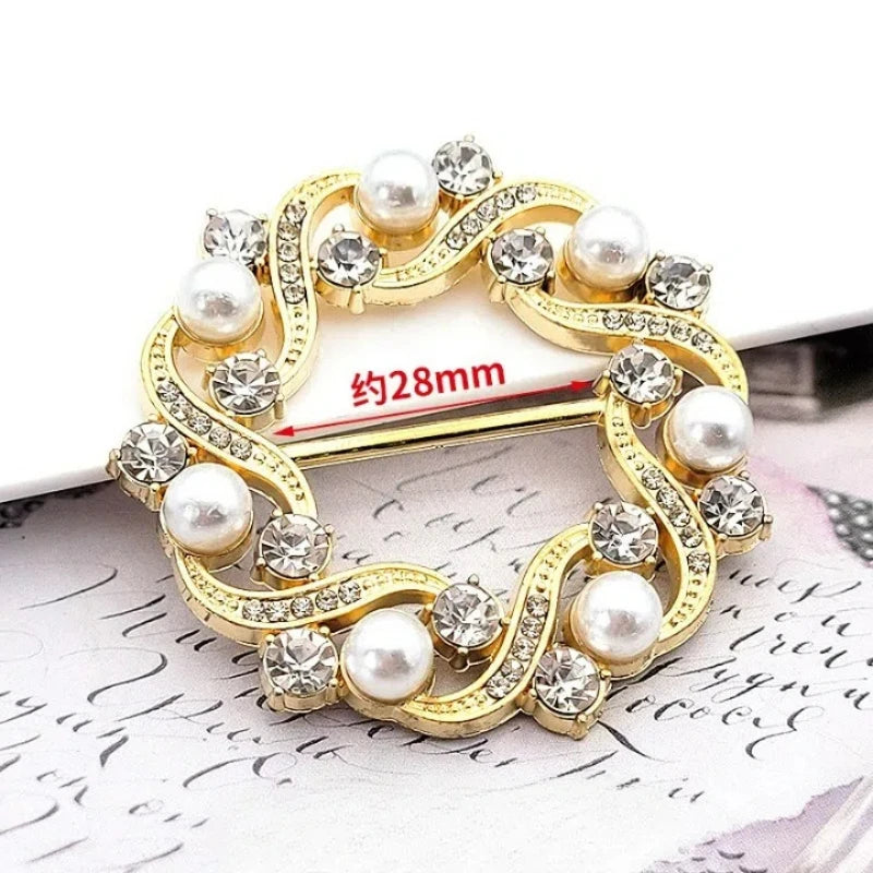 Gold-toned metal ring clips featuring pearl and diamond accents for clothing and accessories