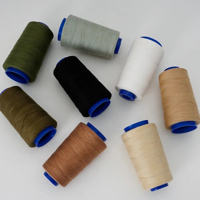 A collection of heavy-duty waterproof sewing thread spools in various colors including olive green, gray, black, white, and t