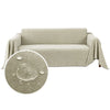 A beige waterproof sofa cover blanket draped over a sofa, with a circular water droplet design nearby.