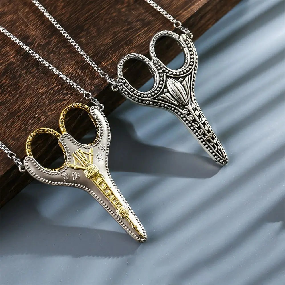 Silver and gold vintage stainless steel sewing scissors hanging on a chain