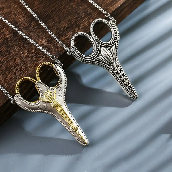 Silver and gold vintage stainless steel sewing scissors hanging on a chain
