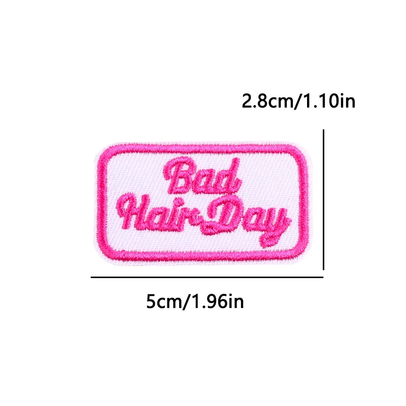 Pink embroidered patch with the text Bad Hair Day on a white background