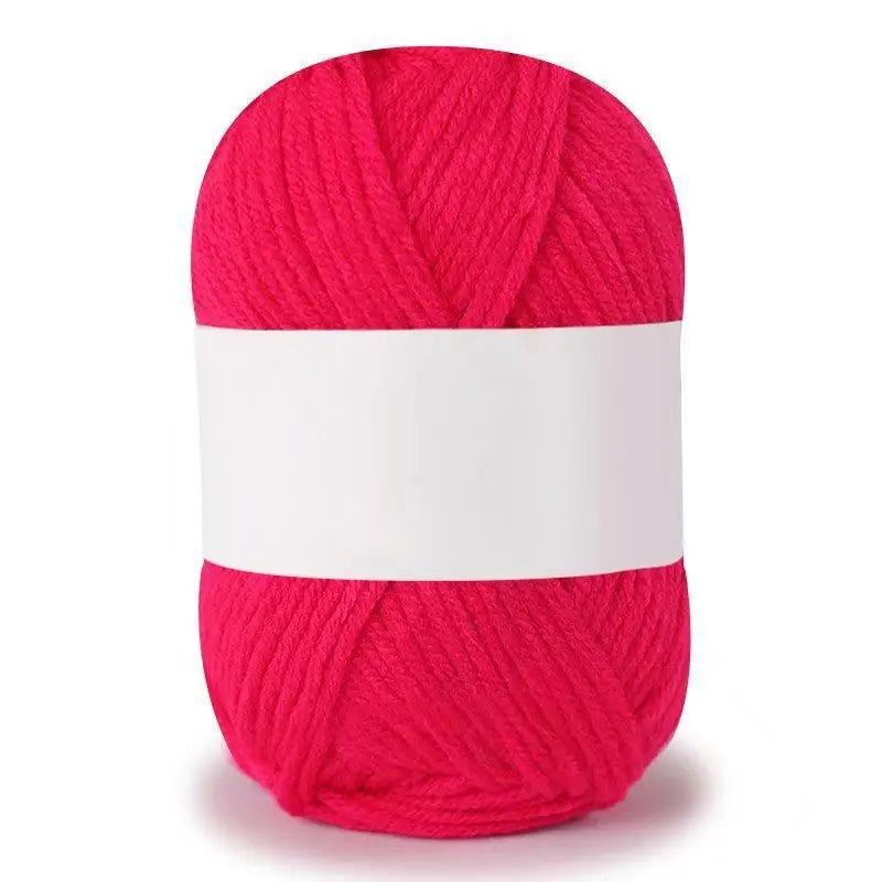A skein of bright pink soft milk cotton knitting yarn rolled into a cylinder.