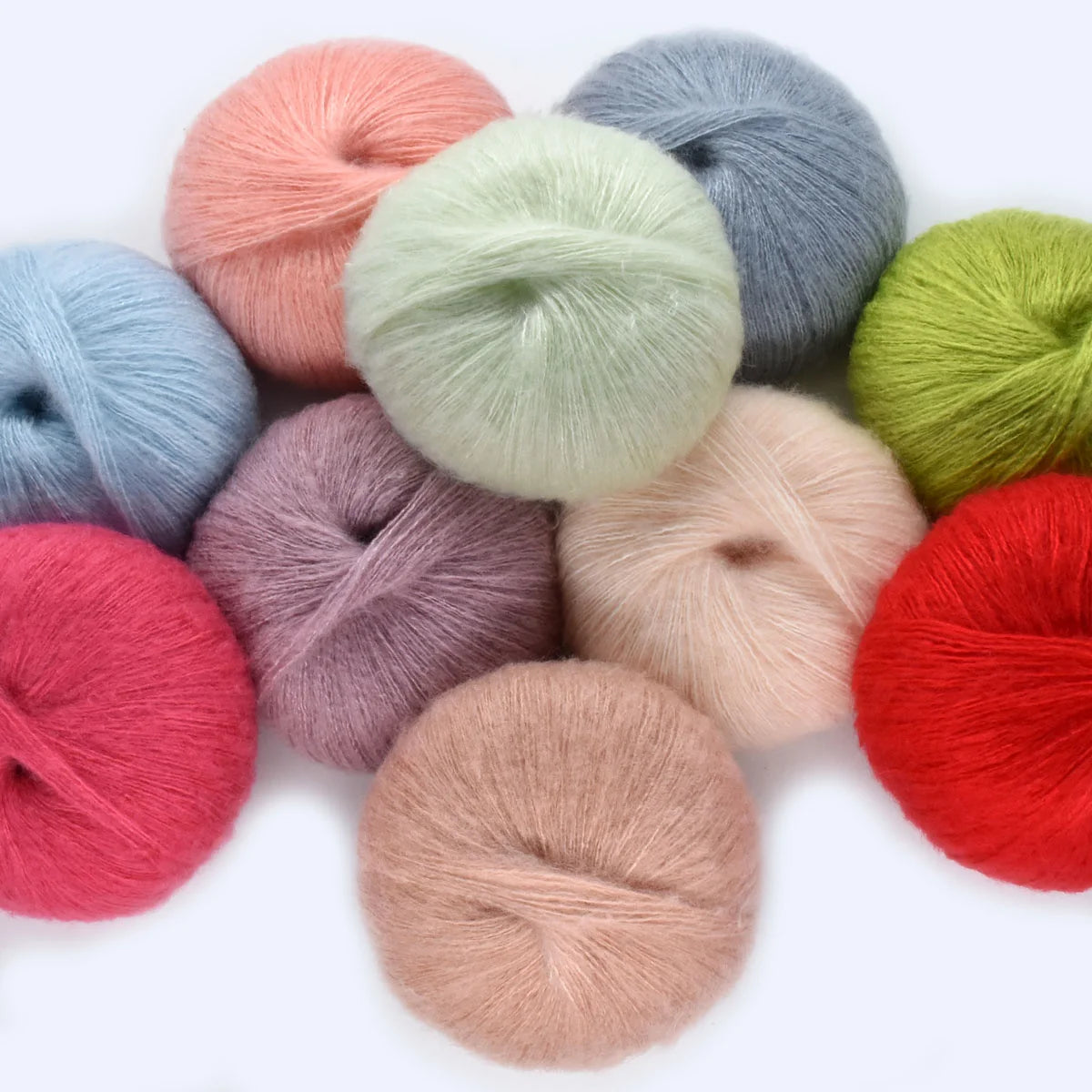 A collection of various colored premium mohair yarn skeins arranged on a white background.